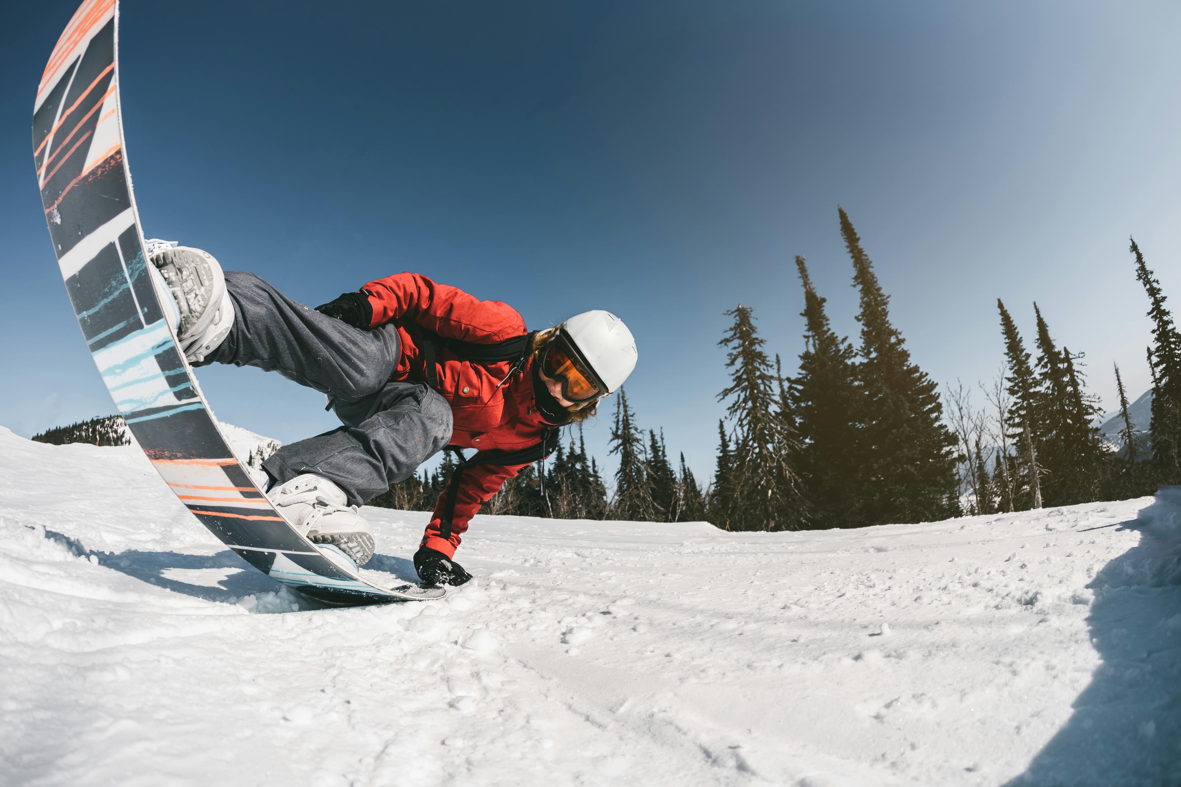 Snowboarder sitting looking at view